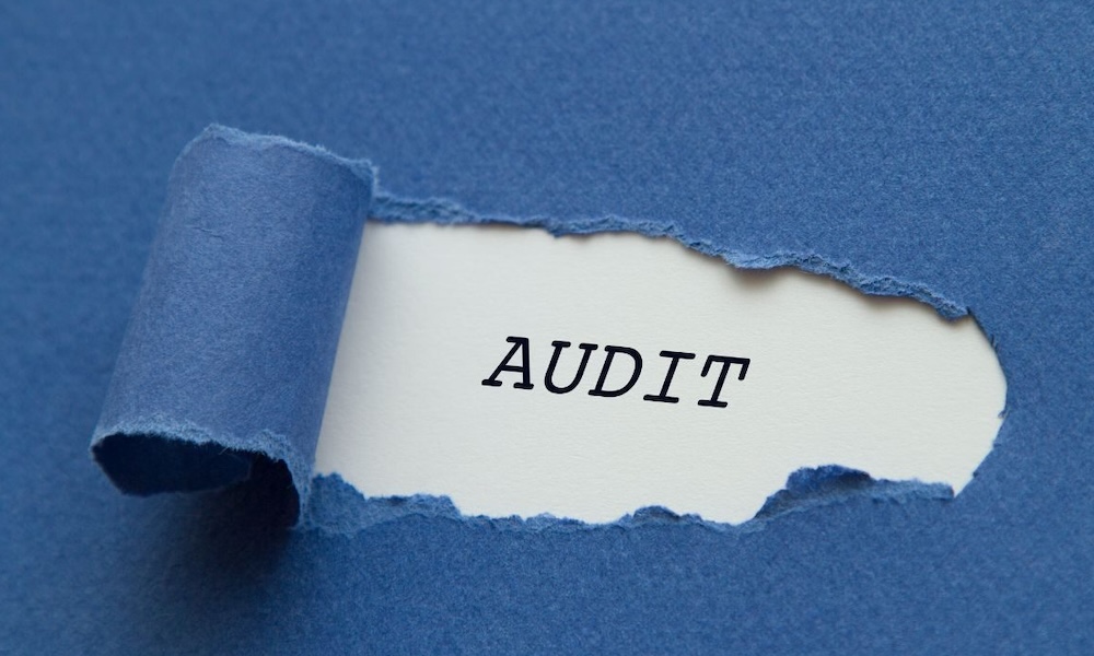 Torn blue paper revealing the word 